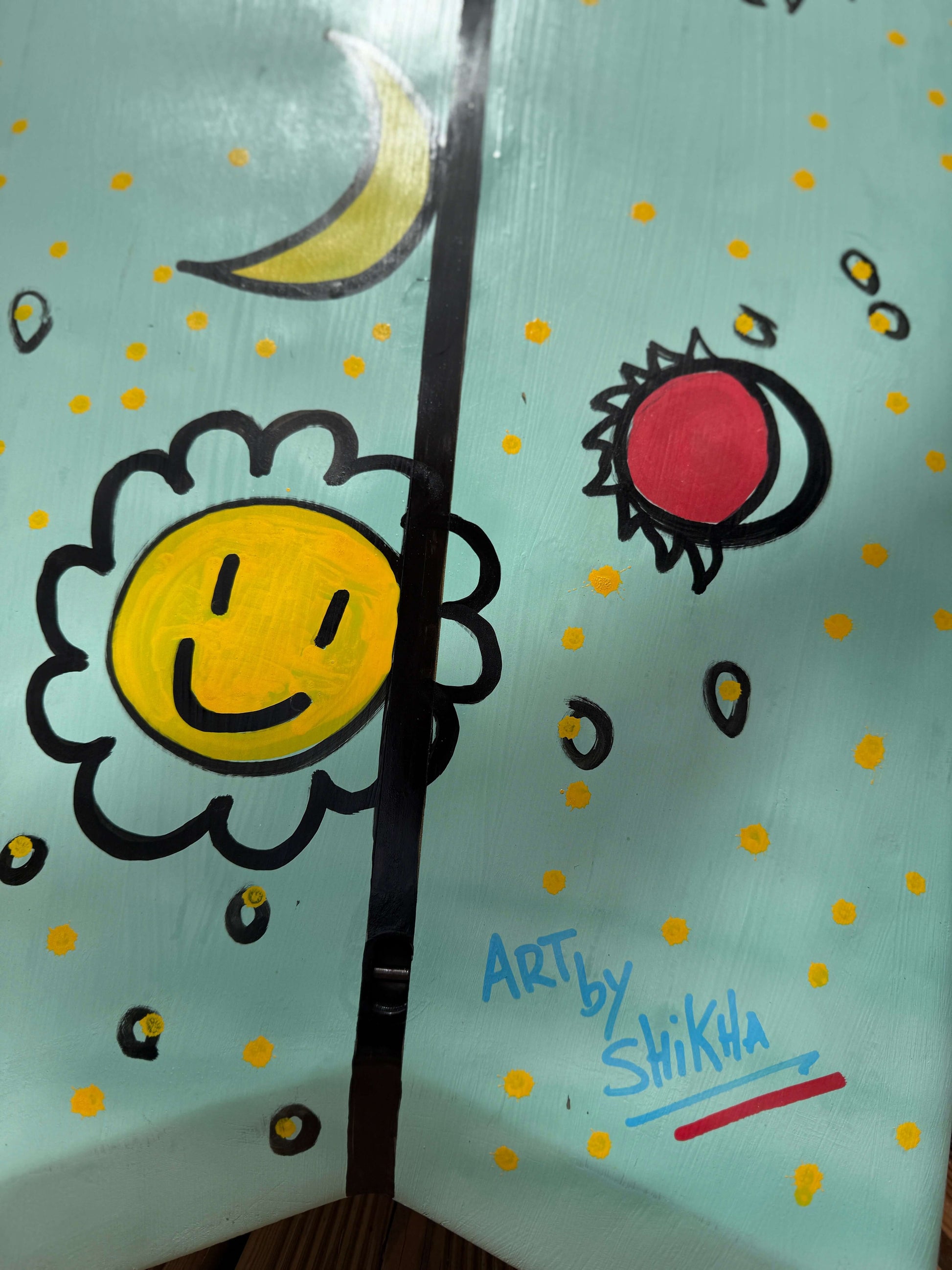 Hand-painted design on the OG Wenzel MiniSimmons Surfboard by SWELLŌ featuring a smiling sun and artistic elements.