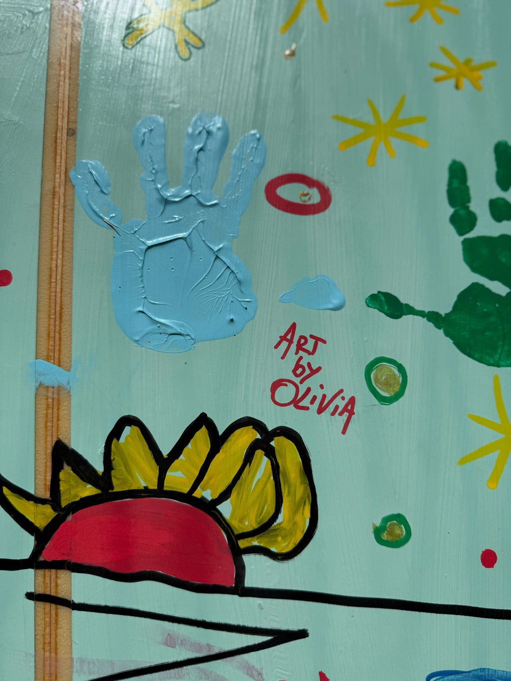 Art close-up of the OG Wenzel MiniSimmons Surfboard by SWELLŌ, featuring handprints and vibrant designs.